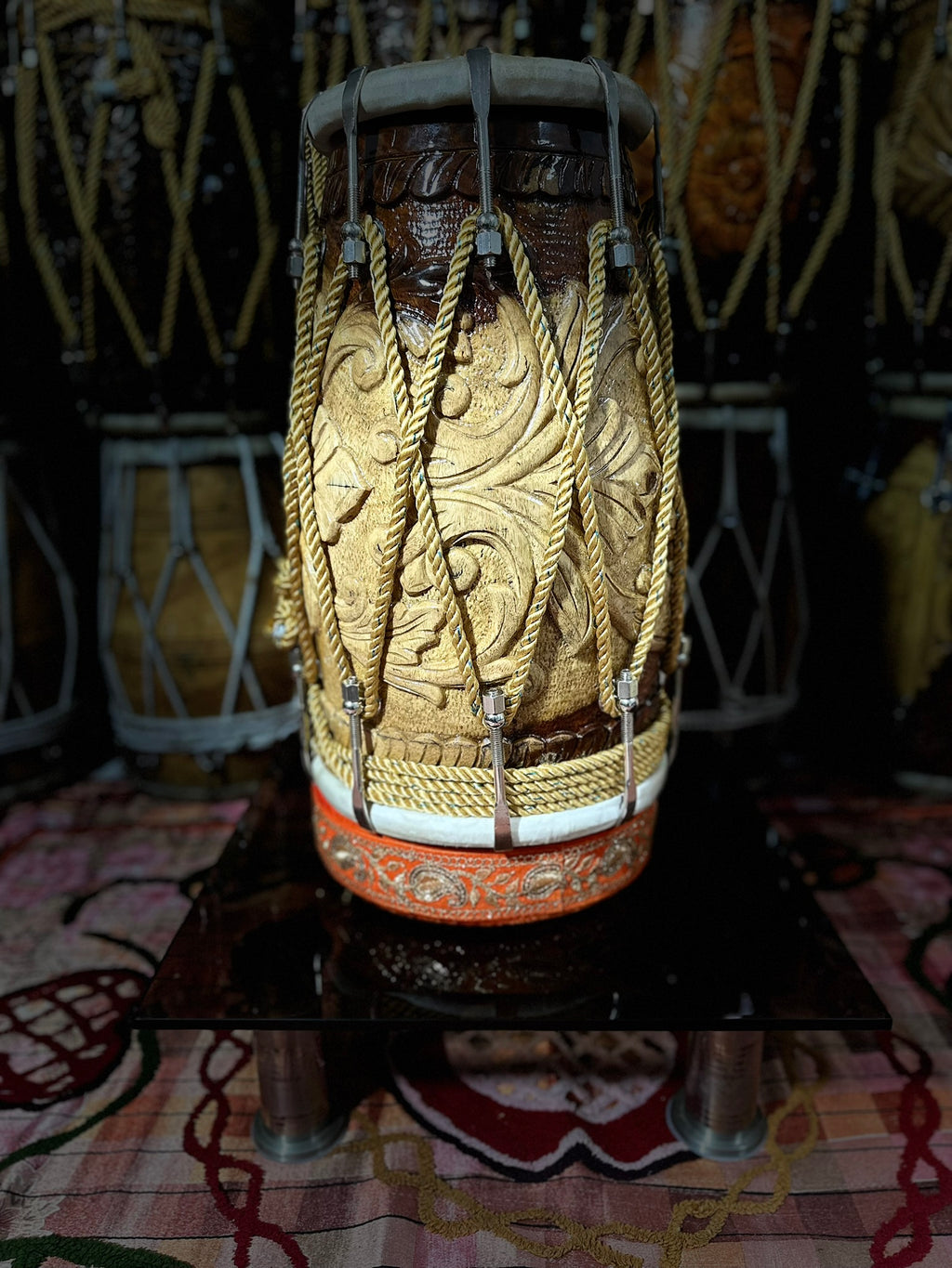 Decorative drum with intricate patterns on a patterned surface