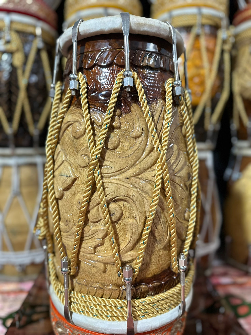 Close-up of a intricately designed drum with decorative ropes and patterns.