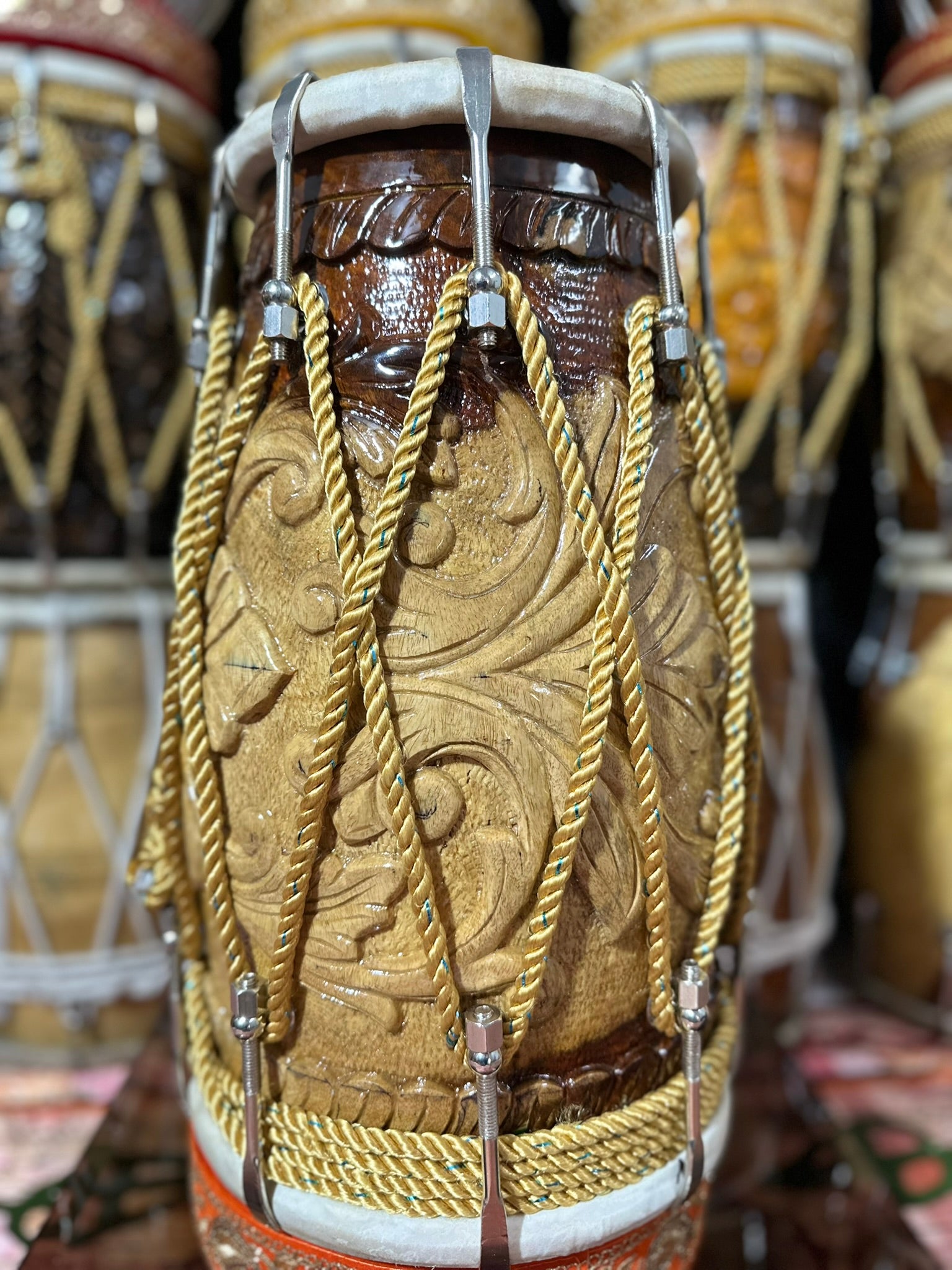 Close-up of a intricately designed drum with decorative ropes and patterns.