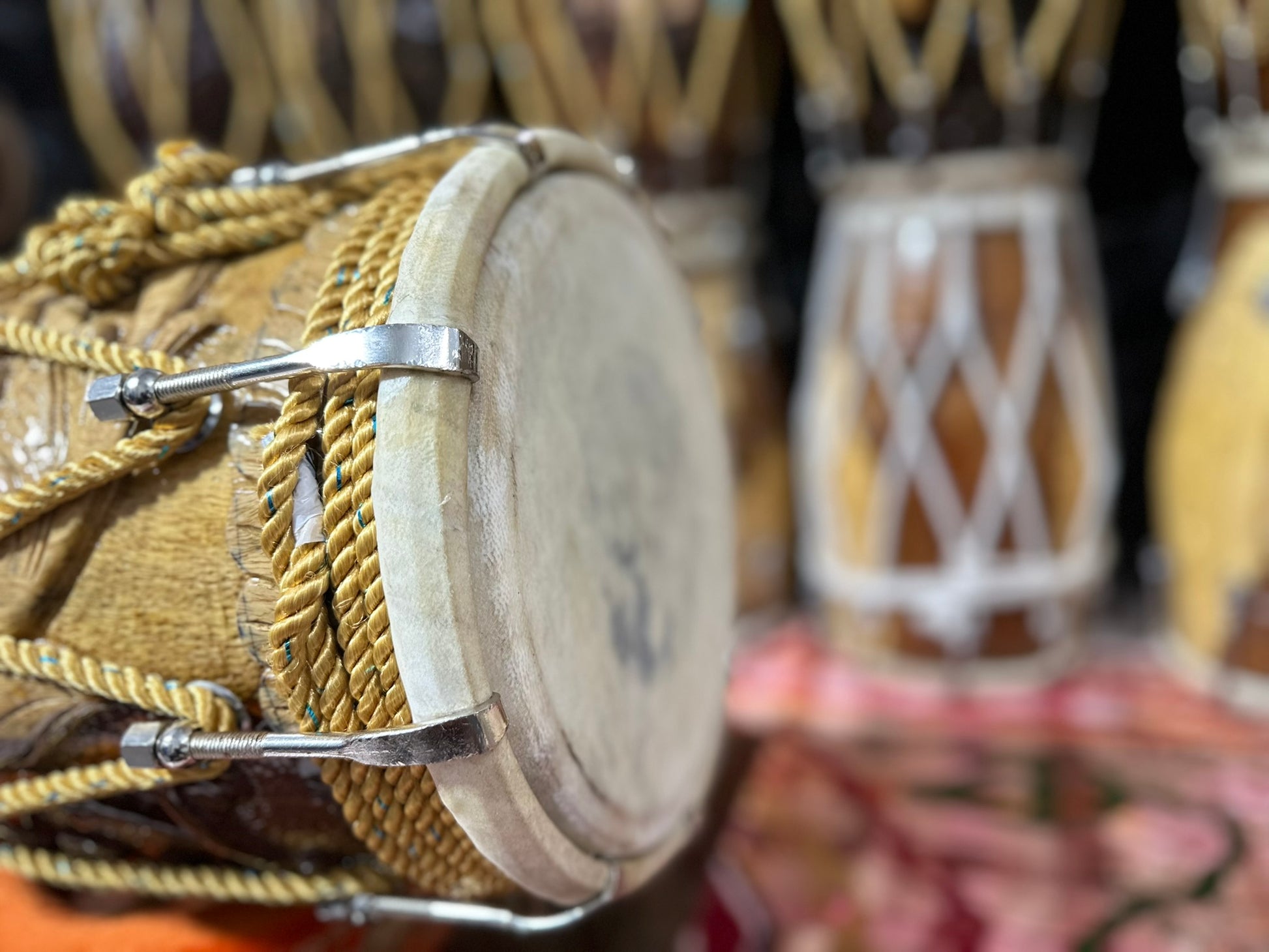 Close-up of a wooden drum with rope wrapping, blurred background